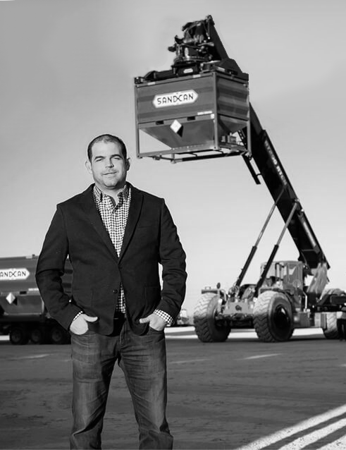 Juan Oziel Medrano standing in front of Sandcan equipment.
